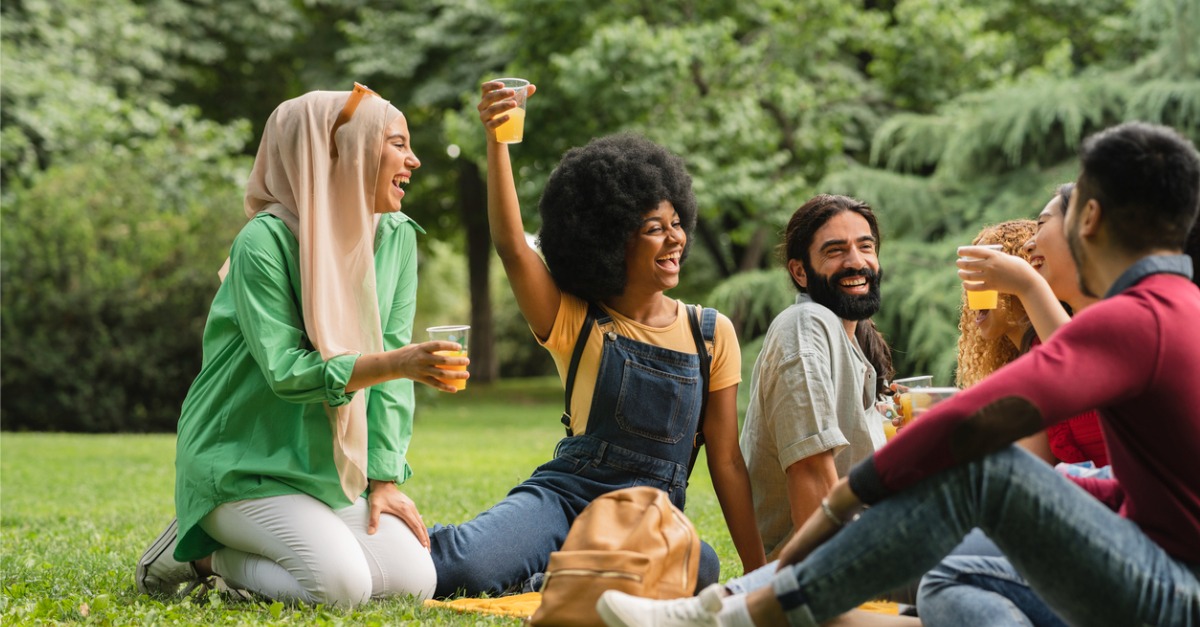 adult friends happy sitting on grass