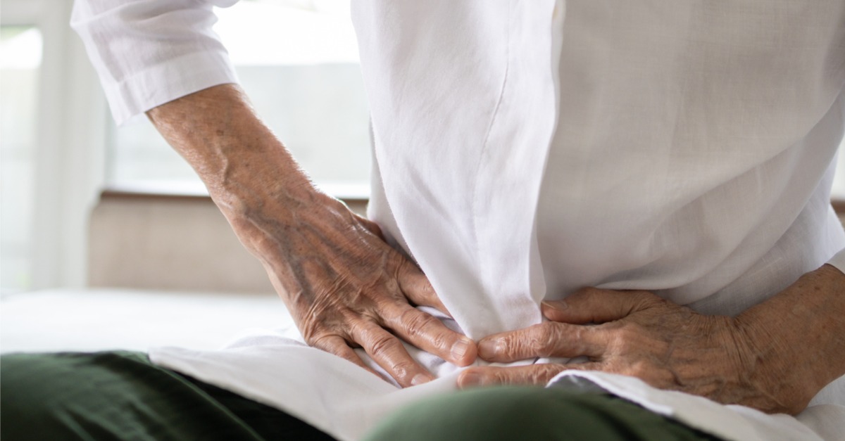 person holding stomach in pain